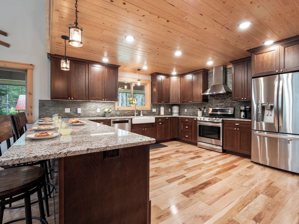 This spacious, fully-equipped kitchen features modern appliances, granite countertops, and a large island—perfect for cooking meals and gathering with loved ones.