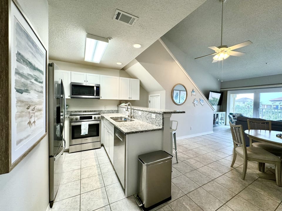 Kitchen with stainless appliances. Microwave and dishwasher. Fully stocked.