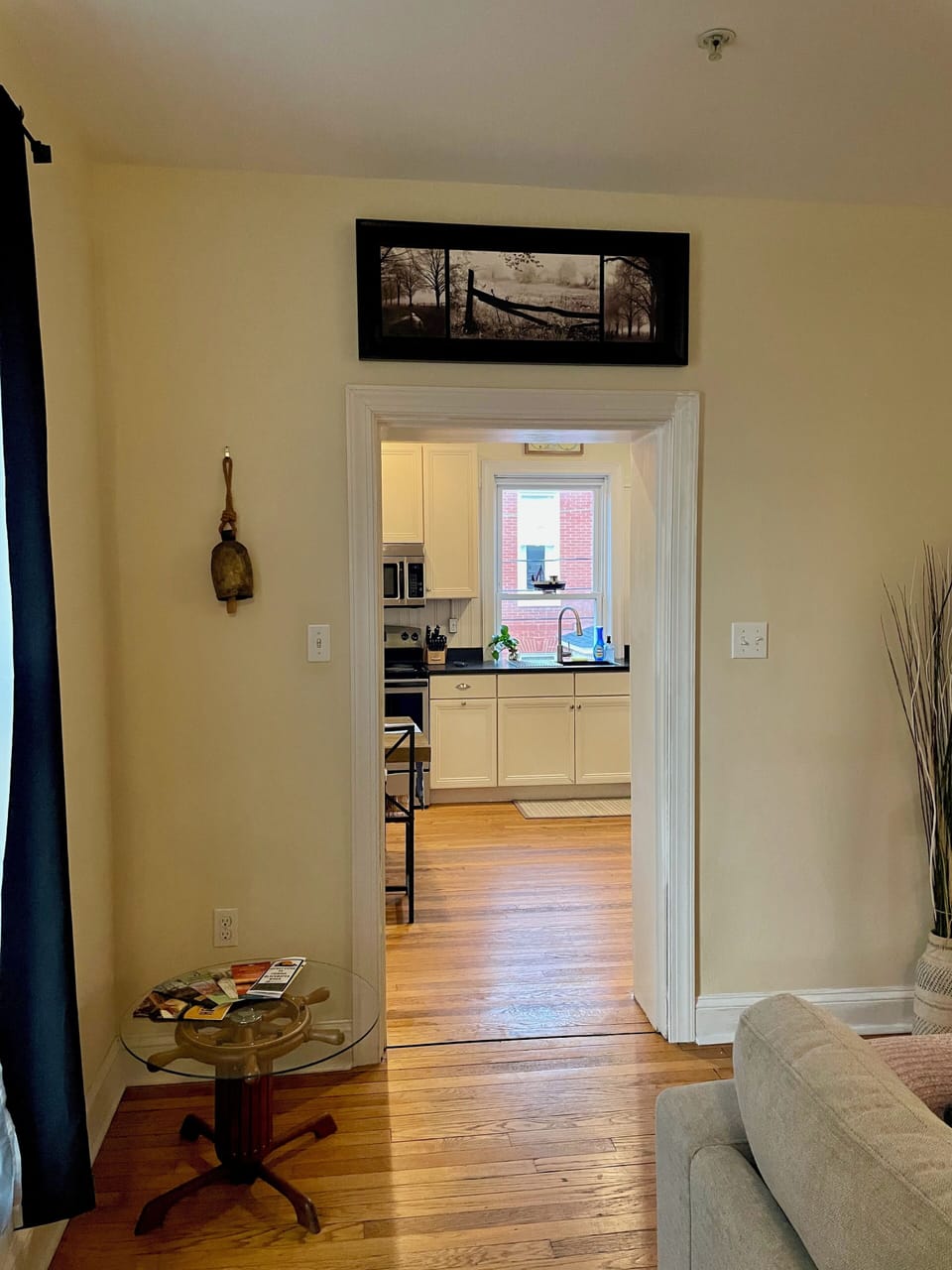 View from entry door through living room to kitchen