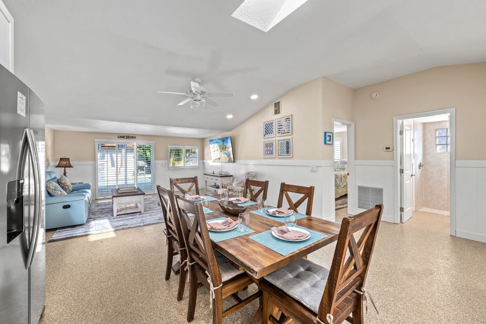 Enjoy meals and relaxation in a sunlit open space where the dining area meets the cozy living room.