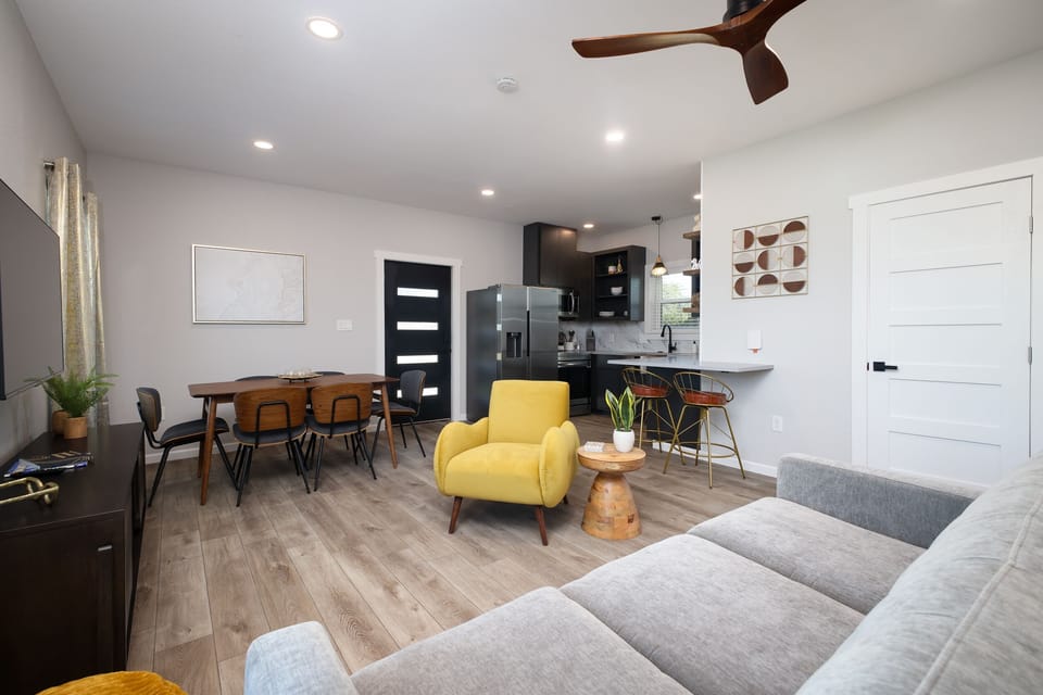 A meticulously decorated and comfortable living area with a pull out queen sofa bed. The sofa bed has a luxurious memory foam mattress with premium cotton linens.