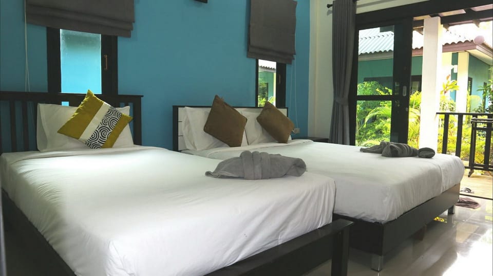 Deluxe Triple Room, 1 Bedroom, Non Smoking, Patio | Minibar, in-room safe, blackout drapes, free WiFi