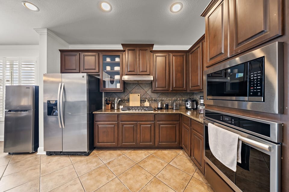 Fridge dispenses water and ice. Stainless steel appliances.