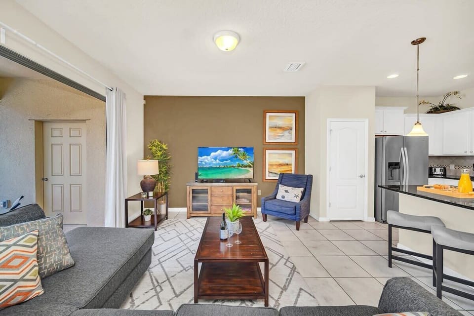 Open-concept living area with a cozy seating arrangement and modern kitchen access.