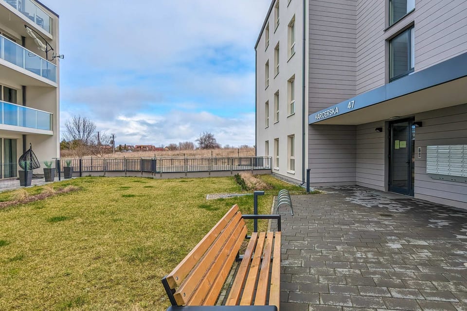 The exterior of a modern building complex with clean lines and well-maintained surroundings.