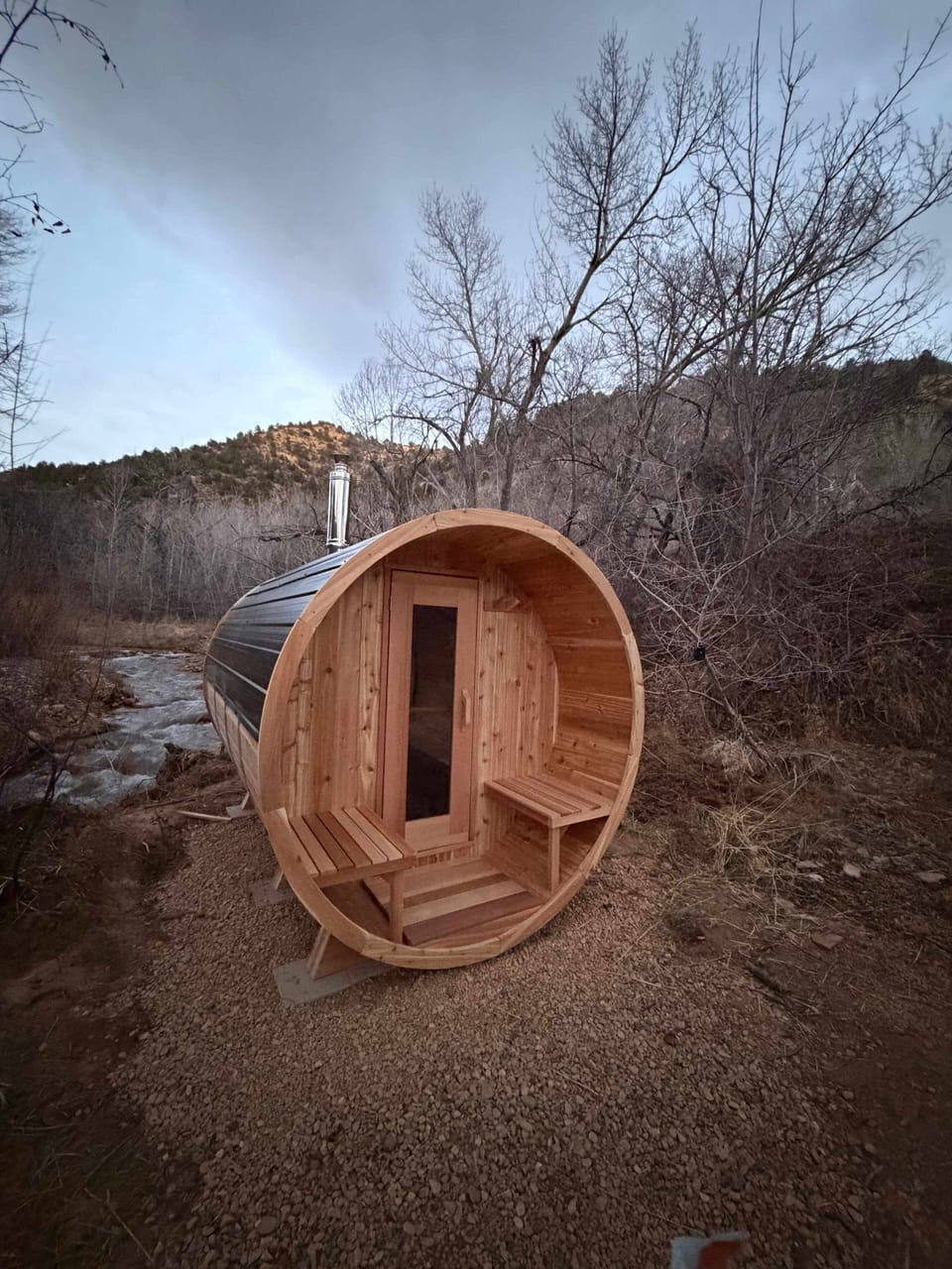 Luxury barrel sauna by the river—soak in the heat, listen to the water.
