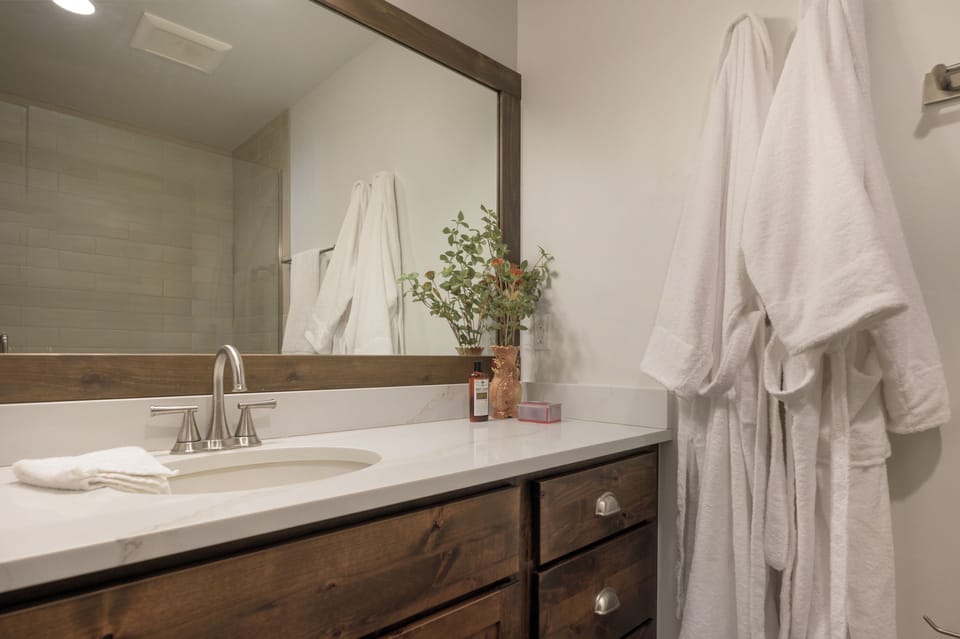 Slip into plush bathrobes and unwind in your spa-like bathroom, complete with fluffy towels and thoughtful amenities for your comfort.