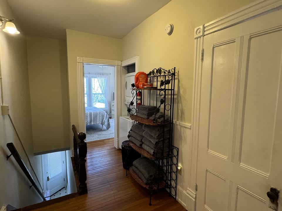 Hallway with laundry and Queen bedroom #2 beyond