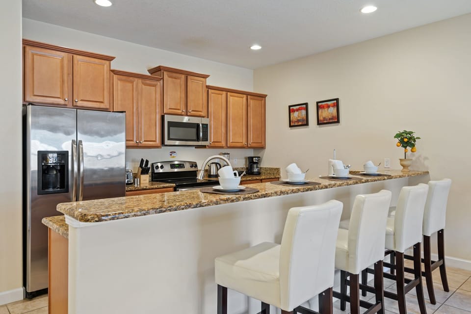 Our spacious kitchen is equipped with an island and bar stools