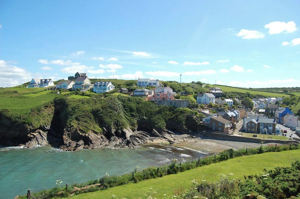 The small sandy cove at Little Haven with the village in view