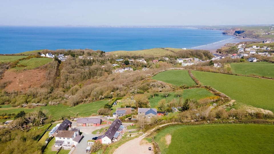 Aerial view of the cottage with sea in the distance