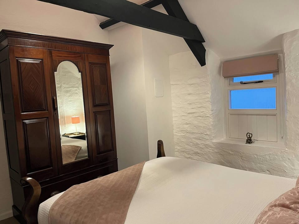 King size bedroom with wardrobe and small window