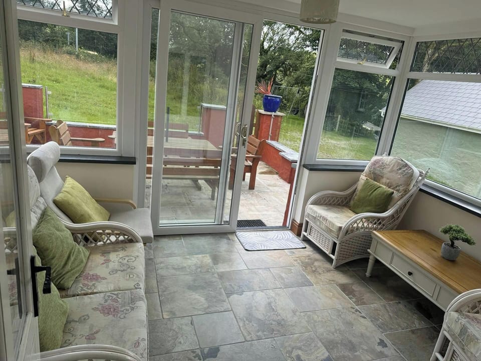 Conservatory with patio doors leading to the patio and garden