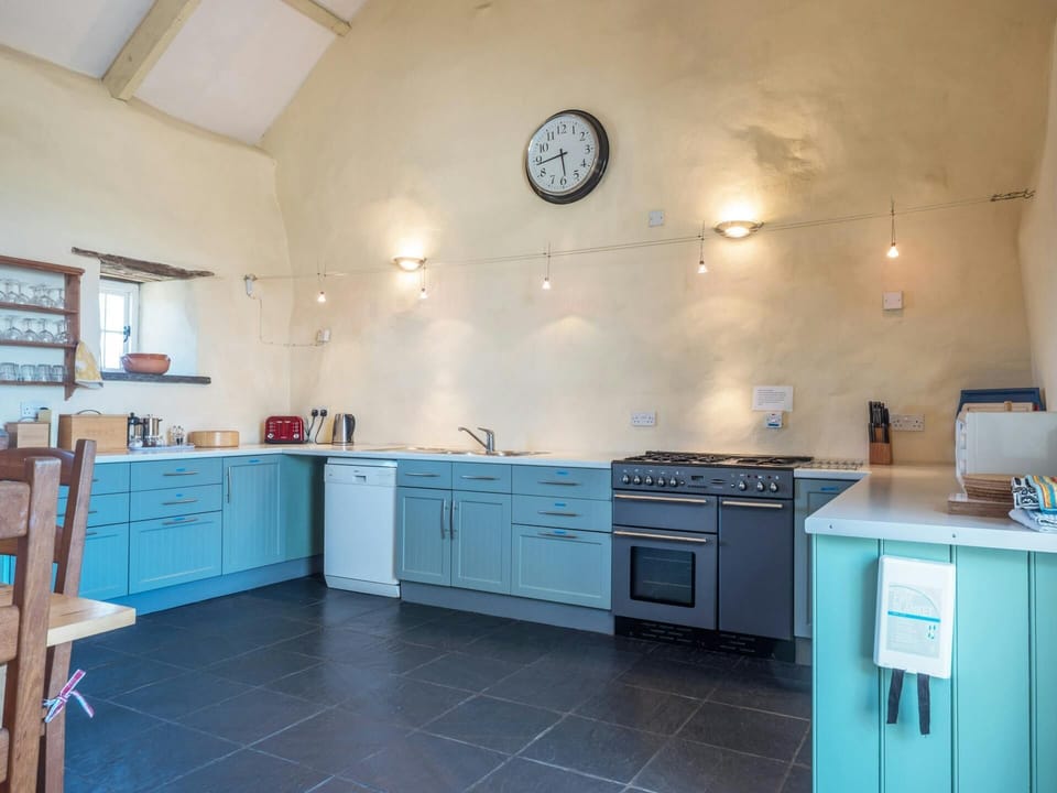 Fitted kitchen with range cooker, dishwasher, microwave, kettle and toaster