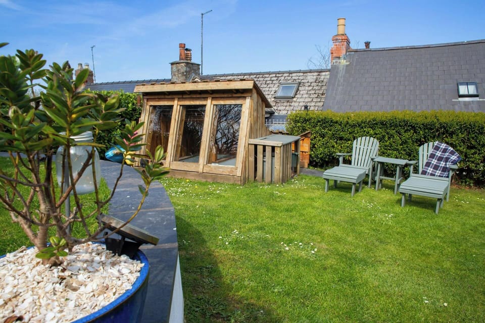 Garden with wooden loungers and table
