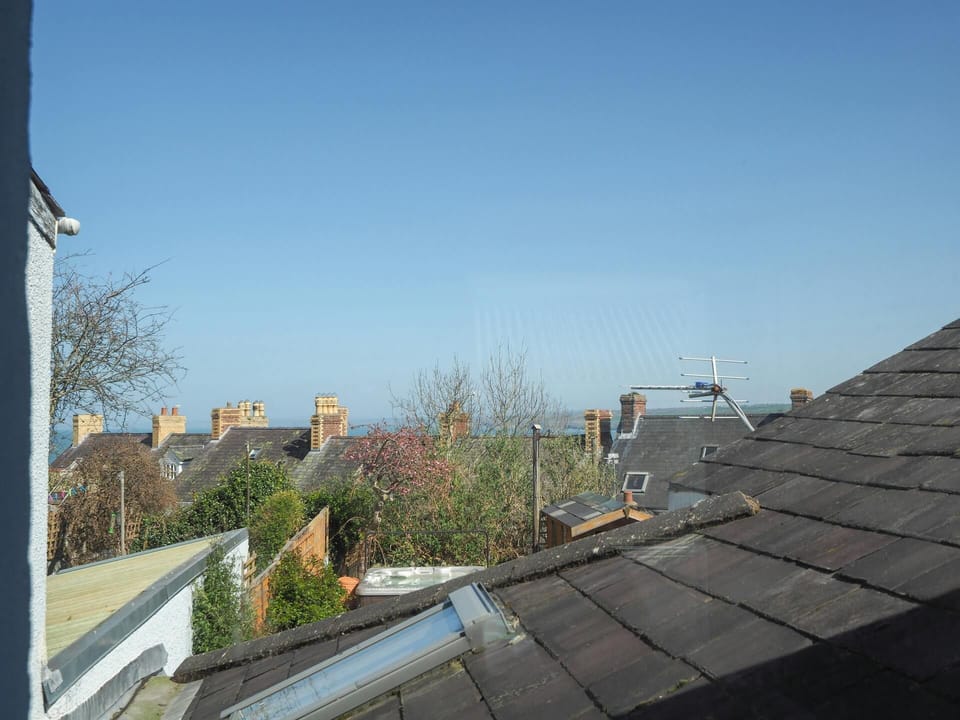 View out the window across the roofs to the sea