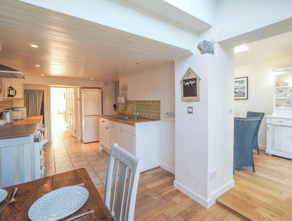 Kitchen with dining table and chairs in the foreground