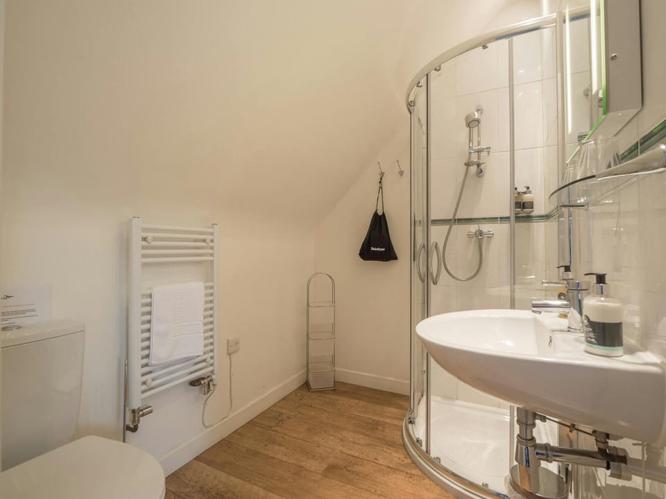 En suite shower room, with hand basin, WC and heated towel rail