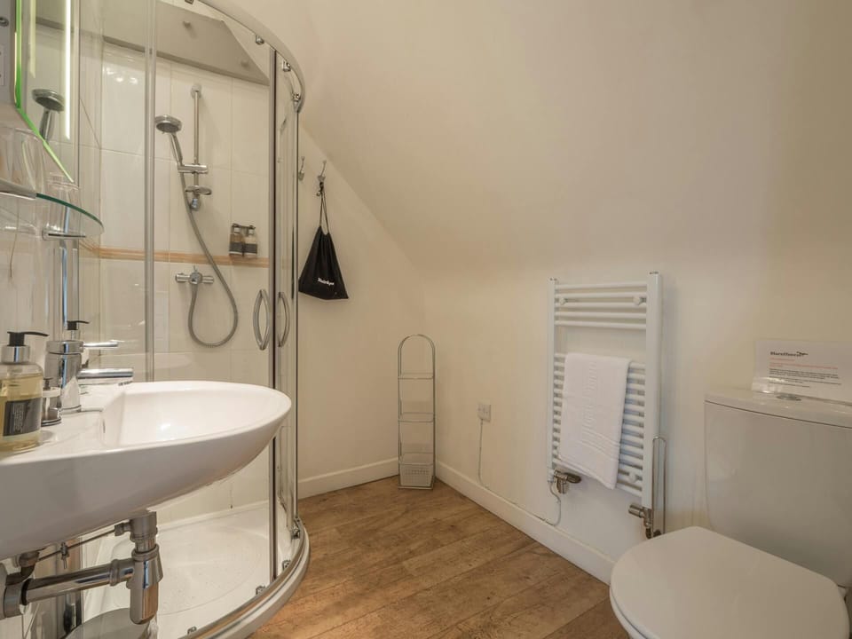 En-suite shower room, with hand basin, WC and heated towel rail