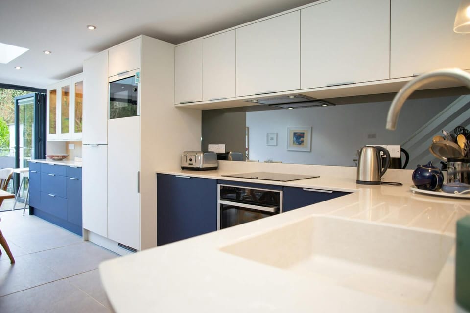 Fitted kitchen with electric hob, oven, kettle, toaster and in-built microwave