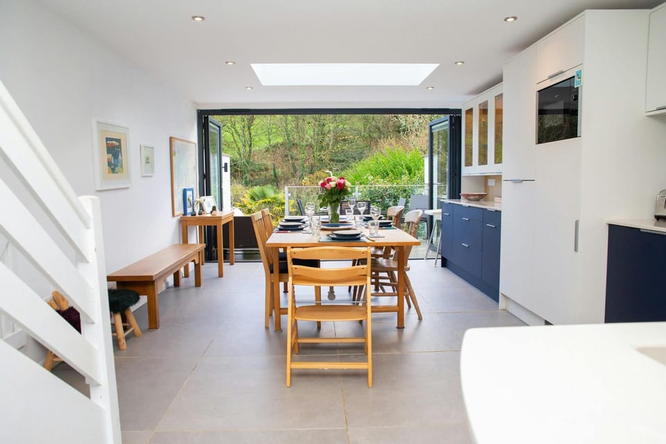 Kitchen/dining area with table and five chairs and doors leading to the terrace
