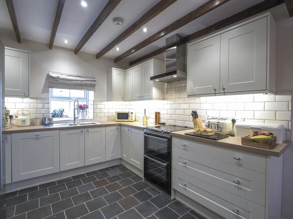 Tiled kitchen floor and beamed ceiling