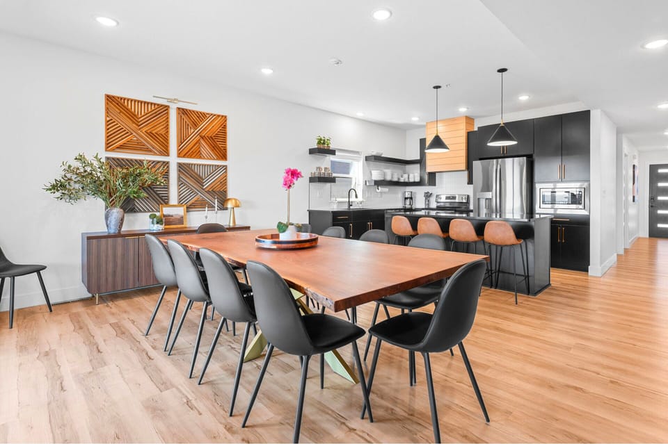Cook, dine, and gather! The sleek kitchen and huge table make mealtime extra special.