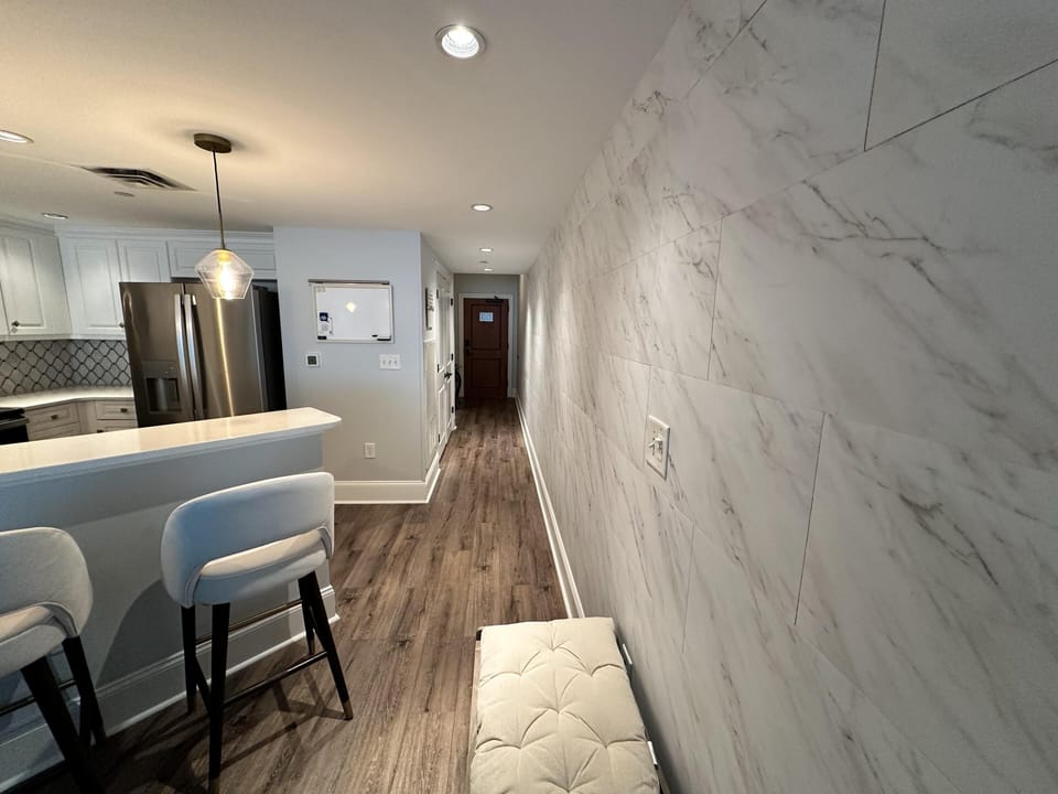 Sleek kitchen and cozy entry with marble accents