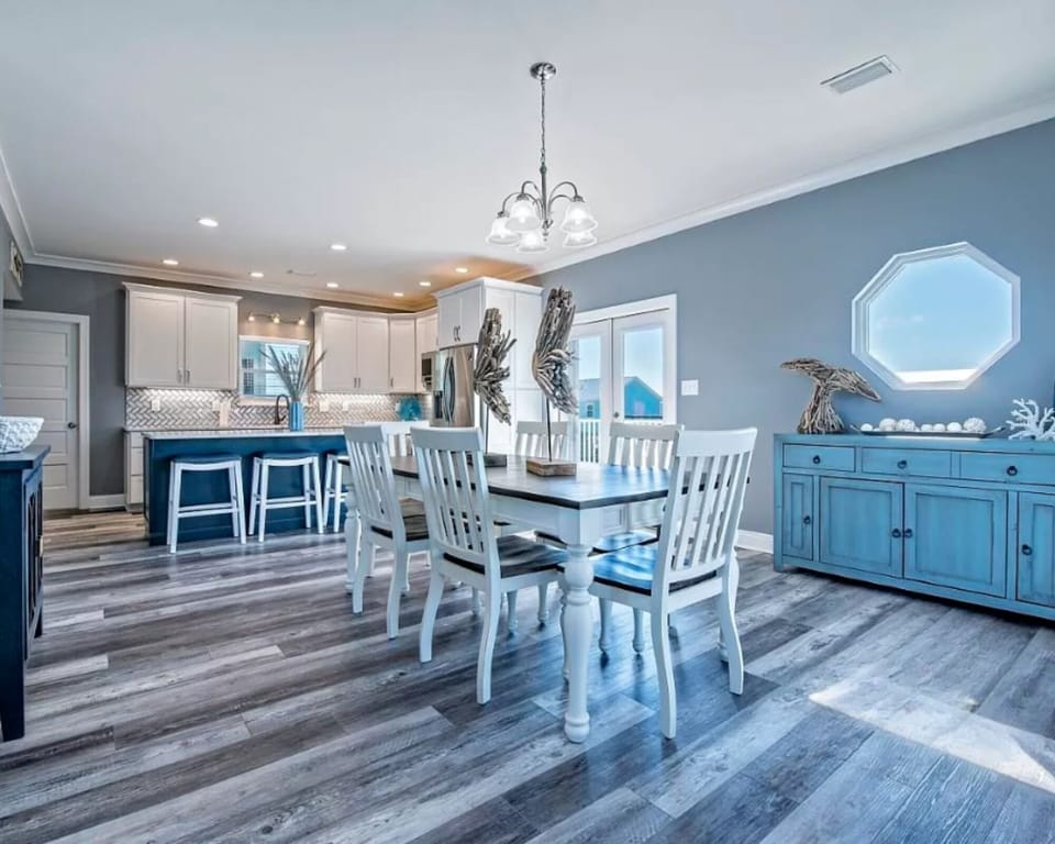 Open dining area with a dining table for 6 and bar seating for 4