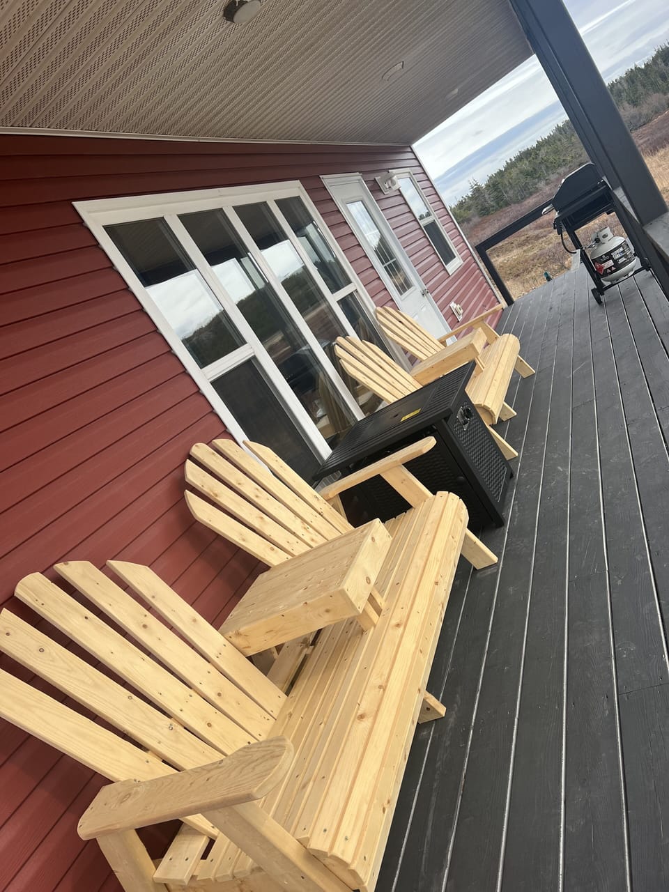 Outdoor sitting area with propane fire pit.