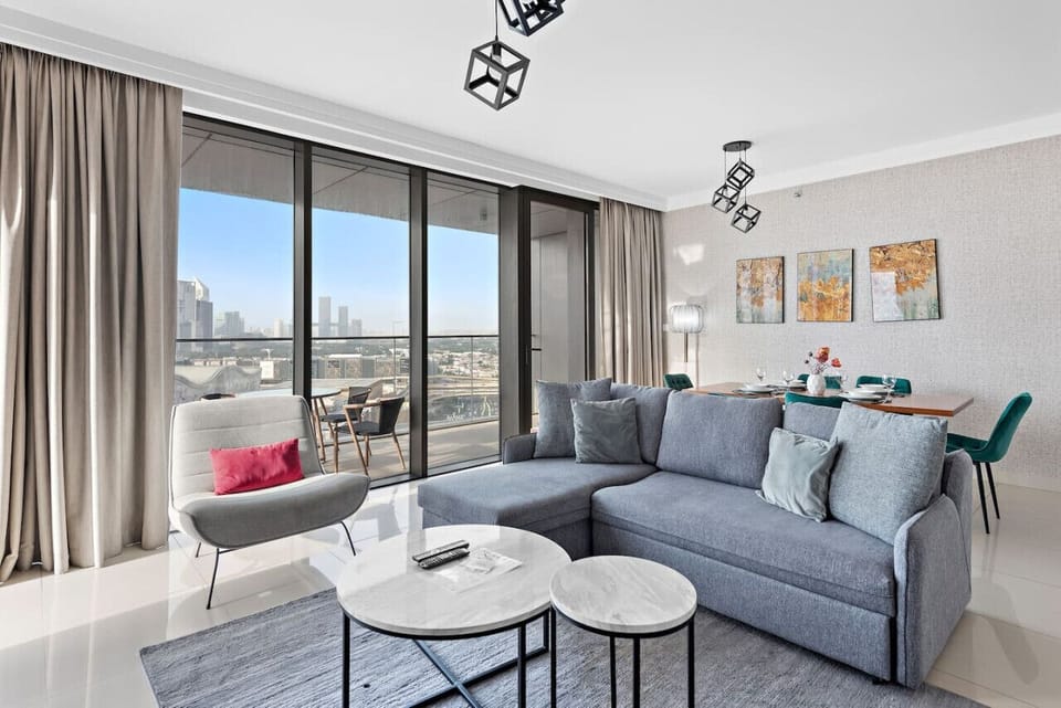 Living Room: Enjoy stunning city views in this stylish space with modern decor and chic furnishings!