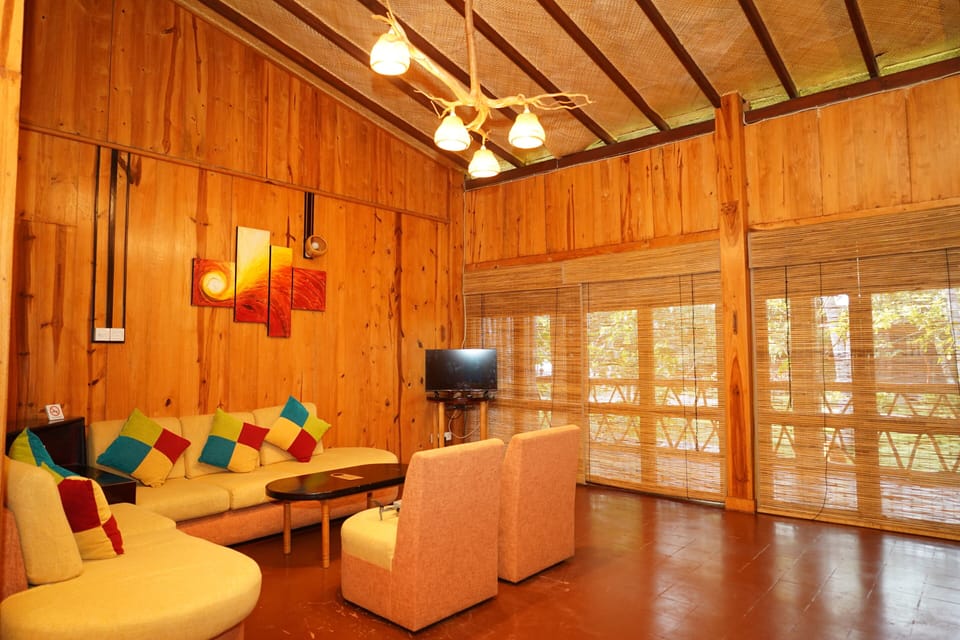 Deluxe Triple Room | Living area | Flat-screen TV, fireplace