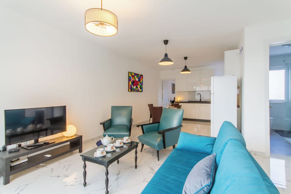 Family Apartment, Multiple Bedrooms, 2 Bathrooms (A Sunny Penthouse Modern 2 bdr -) | Living area | 21-inch flat-screen TV with digital channels