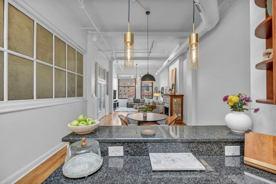 A hallway located behind the kitchen table provides a seamless transition into the living room, keeping the space open and well-connected.
