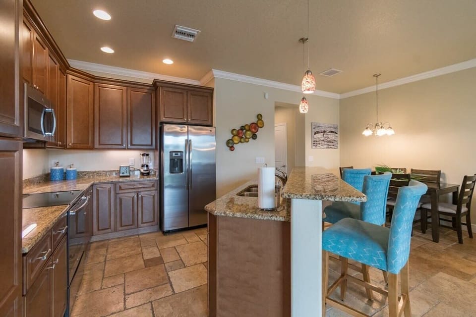 modern kitchen with granite countertops and blue upholstered bar stools