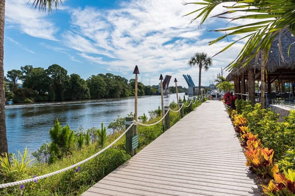 Relax on the waterfront boardwalk with tropical landscaping and river views.