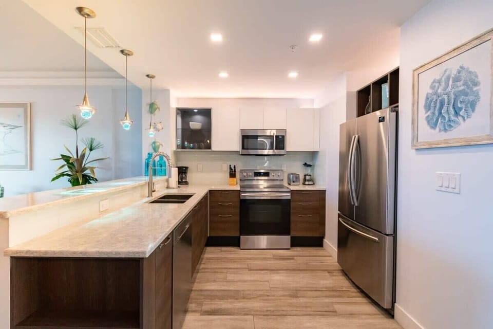 Modern kitchen with stainless steel appliances and marble countertops