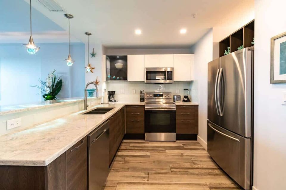 Modern kitchen with stainless steel appliances and marble countertops