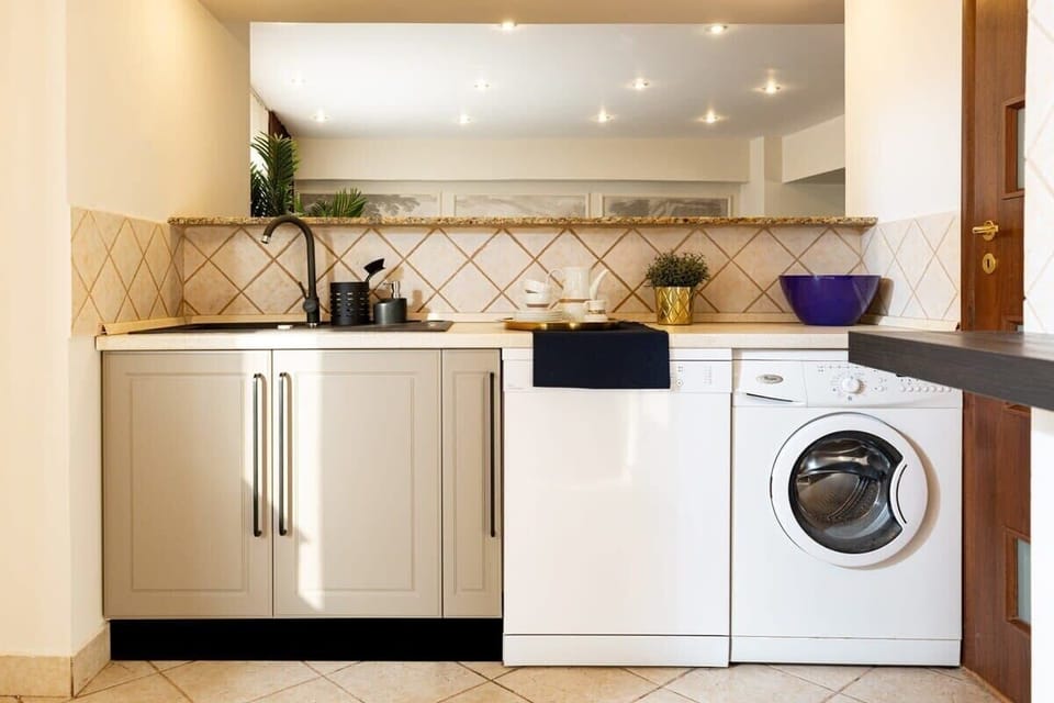 Experience convenience and luxury in our modern washing area, featuring top-of-the-line washer and dishwasher appliances, ensuring effortless cleanliness and efficiency in style.