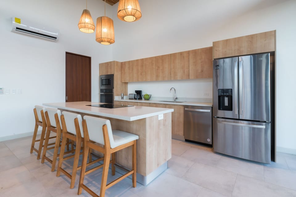 Sleek kitchen with island seating and modern appliances