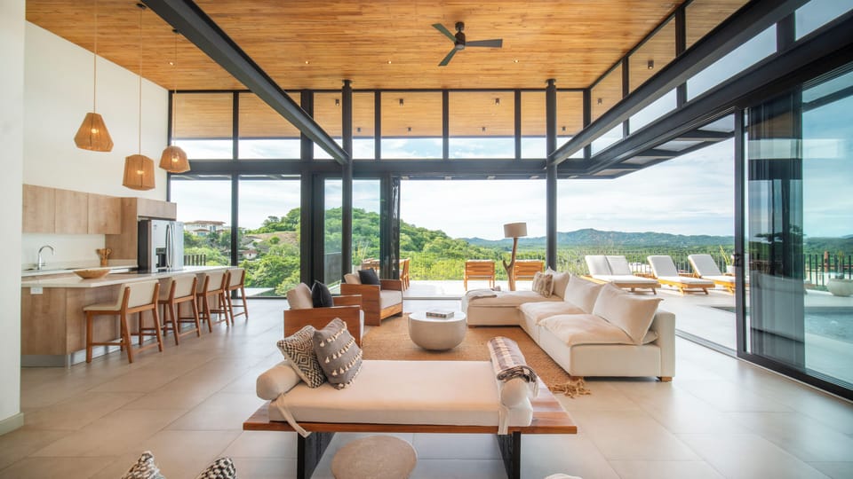 Spacious living area with high ceilings and full-length windows