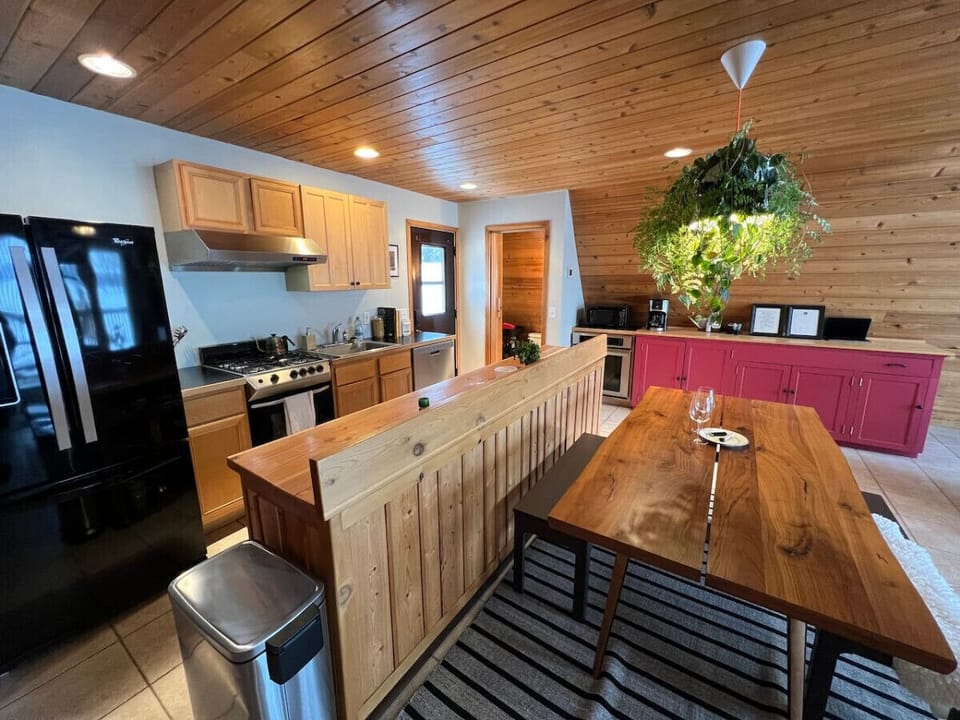 The open kitchen and dining area in the A-Frame -- perfect for romantic dinners and sunlit breakfasts.