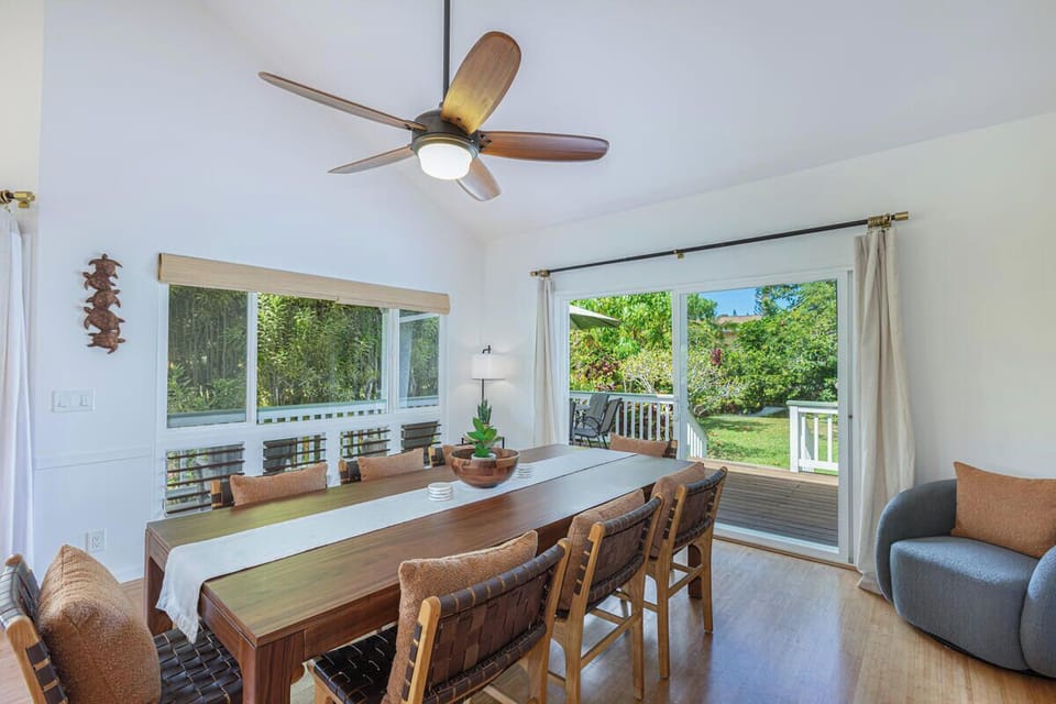 Enjoy meals at the dining table with garden views and easy access to the lanai for indoor outdoor living.