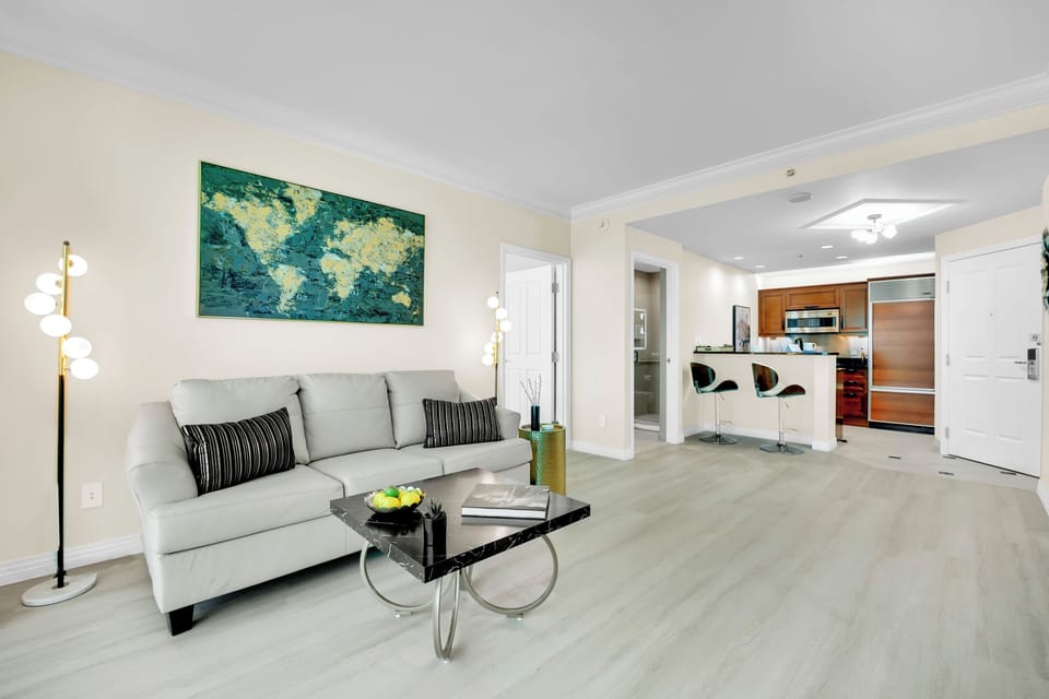 The roomy living room includes a large pull-out sofa and access to a second full bathroom, comfortably sleeping up to four guests.