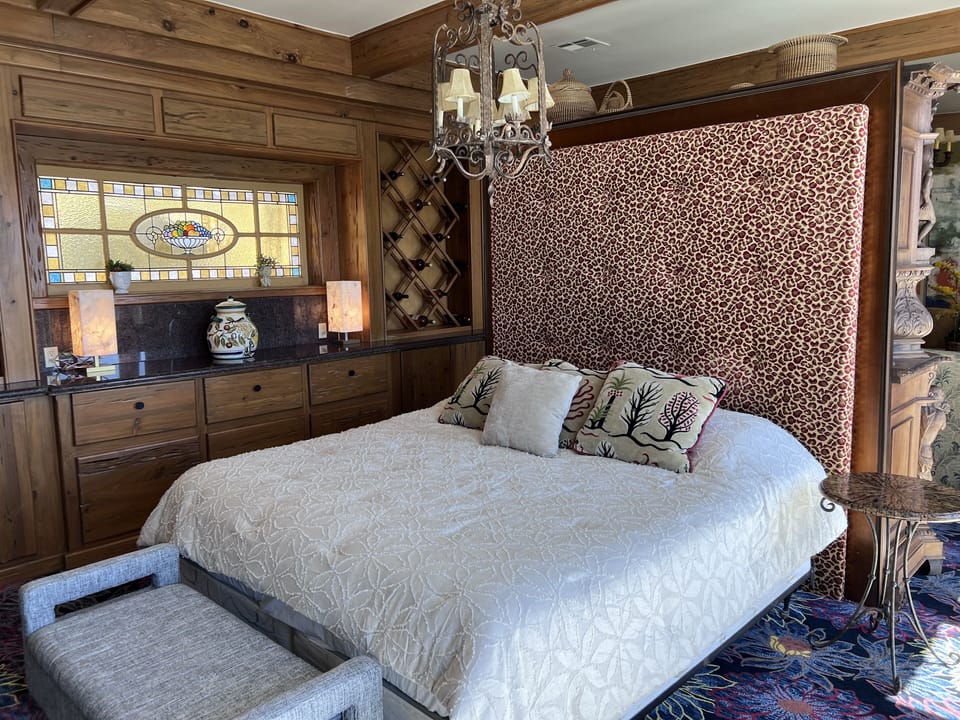 Comfy king bed looks out onto balcony and Lake Travis Sunsets