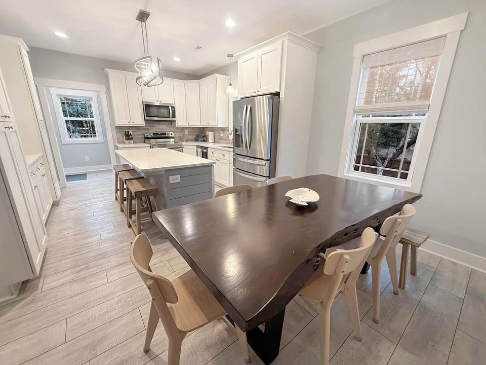 Bright chef's kitchen with island seating and live-edge dining for 8