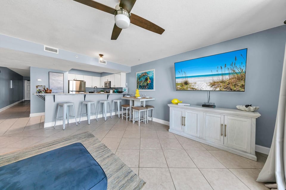 Your open-plan living space blends coastal comfort with modern convenience, featuring a full kitchen and entertainment area perfect for beach vacation memories.