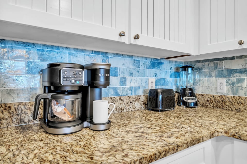 Start your mornings right with premium coffee facilities featuring a Keurig machine and all essentials on elegant granite counters.
