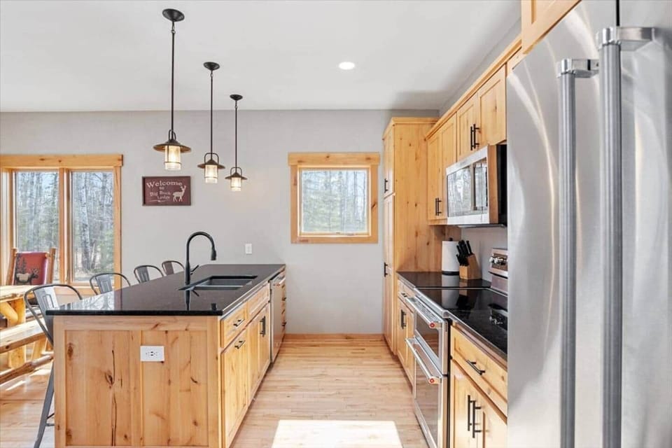 Hickory cabinetry and granite countertops with sunken double stainless sink. 