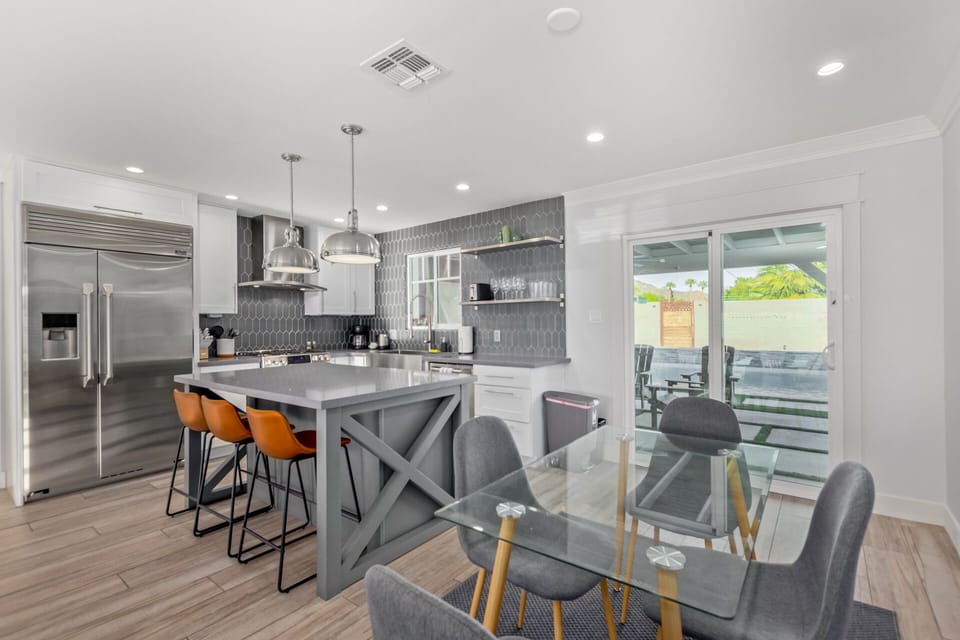 Modern chef kitchen and dining area.